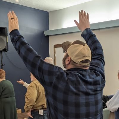 Worshippers raising their hands during a church gathering